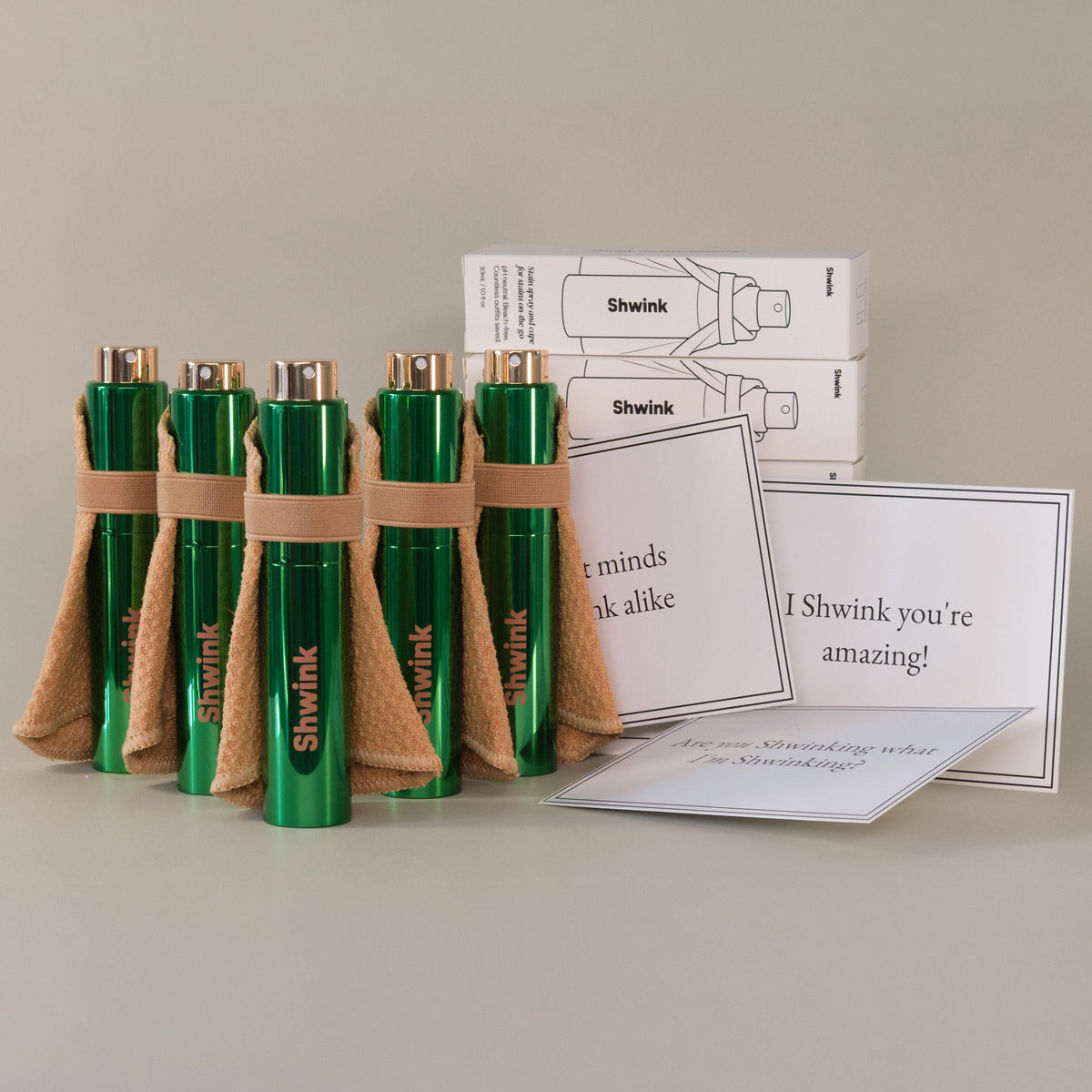 Five green metallic Shwink on-the-go stain sprays with stain lifting capes. Includes five complimentary gift cards  and envelopes. Five perfect gifts for friends, colleagues, mothers, more. 